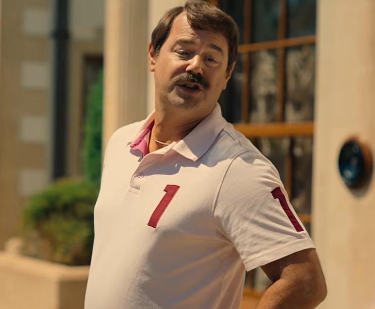 Tony Baddingham in a light pink polo shirt with a red number '1' on the chest and sleeve.