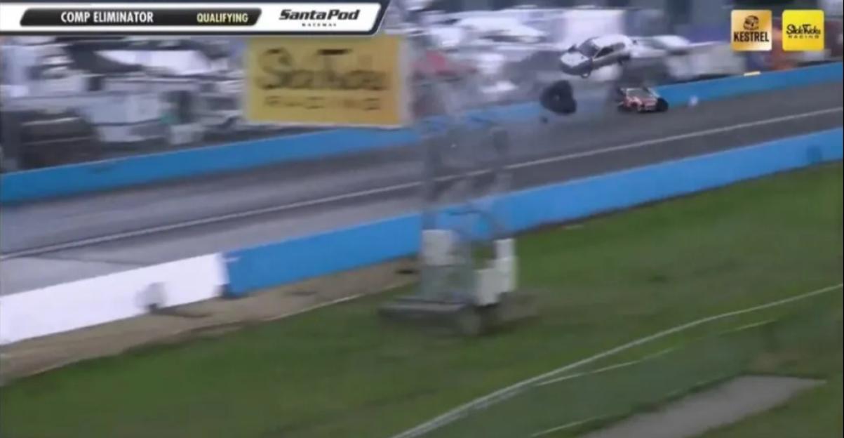 A car crashing and flipping in a drag race event.