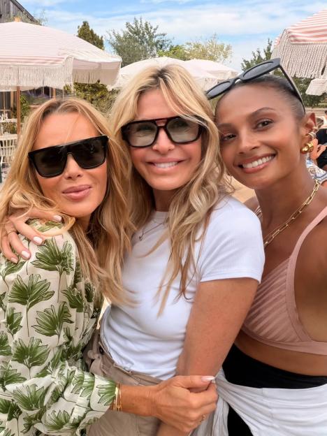 Amanda Holden, a blonde woman, and Alesha Dixon, a dark-haired woman, smile together in a selfie.