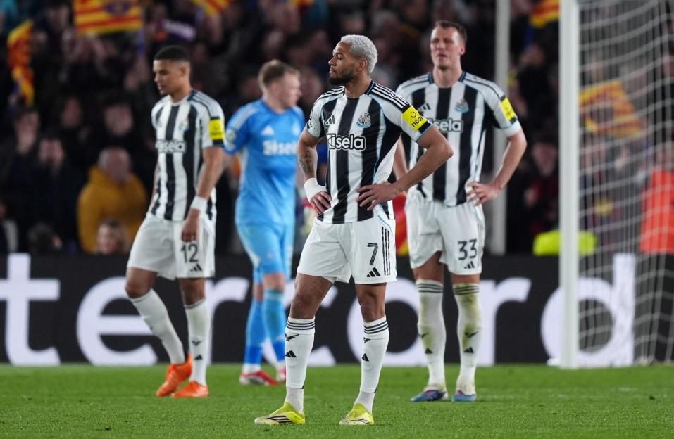 Newcastle United's Joelinton appears dejected after Barcelona scores a sixth goal during a UEFA Champions League match.