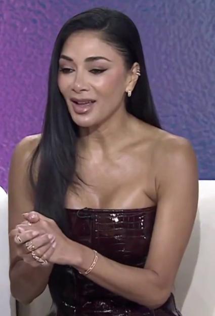 Nicole Scherzinger looking awkward during a TV interview.