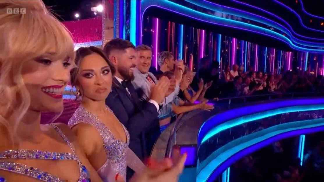 Katya Jones and fellow actors clapping in an audience.