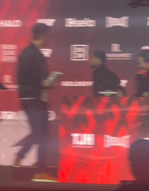 Shakur Stevenson racing across the stage to confront Teofimo Lopez.