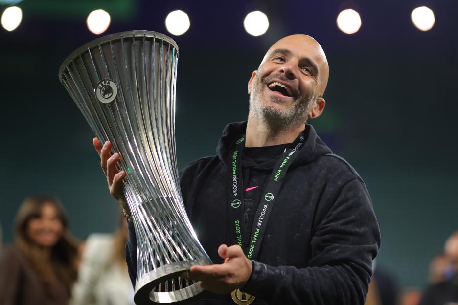 Enzo Maresca, manager of Chelsea, lifts the UEFA Europa Conference League trophy.