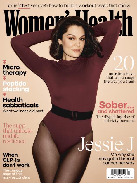 Jessie J on the cover of Women's Health UK magazine, wearing a maroon bodysuit and black tights, with her arms above her head.
