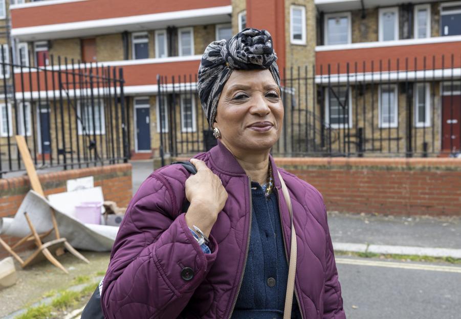 Social worker Evonne smiling in front of the Aylesbury Estate.