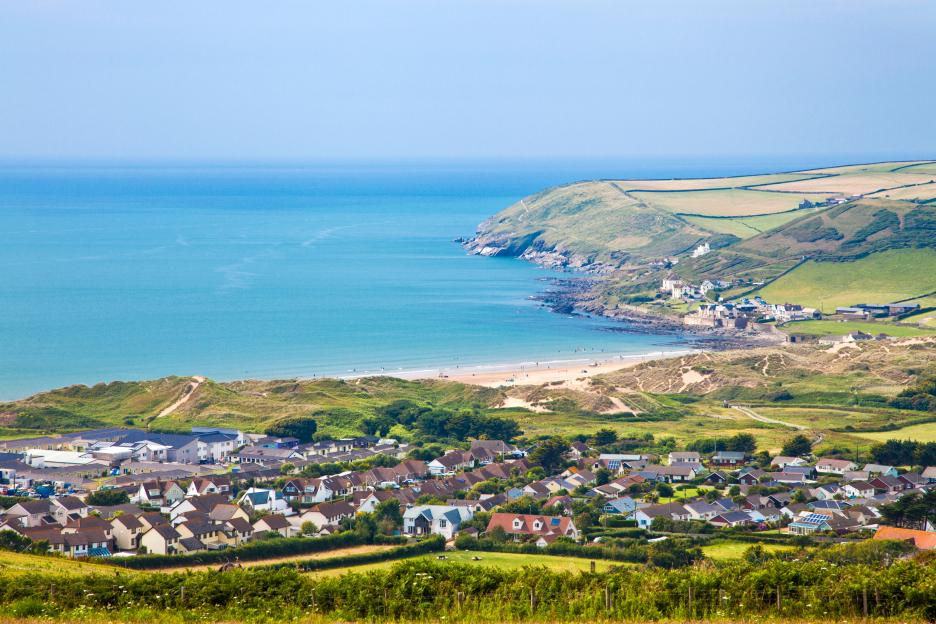 Aerial view of Croyde village, Devon, England, showing the village, beach, and ocean.
