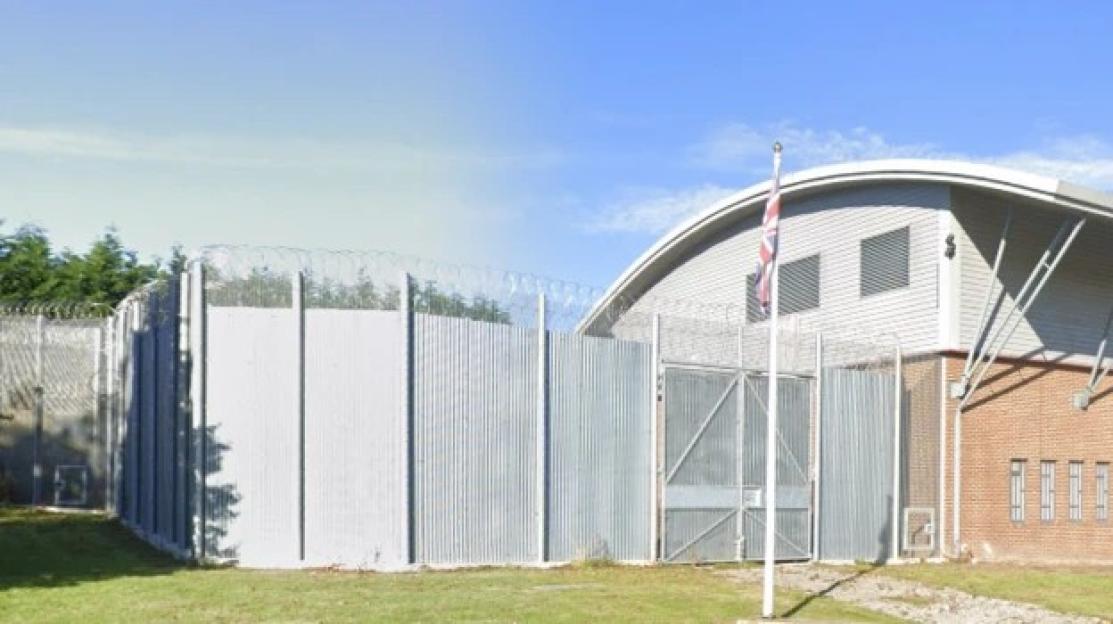 HMP Deerbolt entrance with a Union Jack flag on a flagpole.