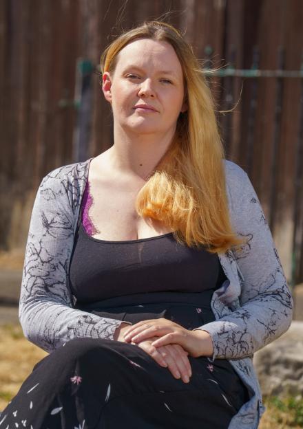 Kelly Whitehead sitting outdoors.