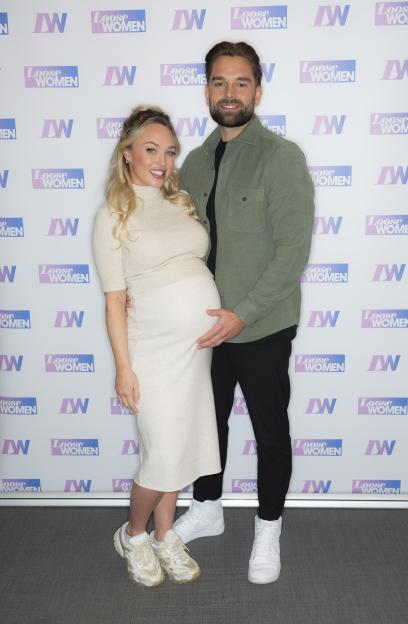 Jorgie Porter and Ollie Piotrowski posing for a photo.