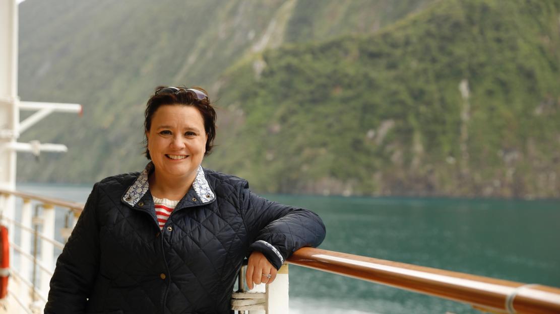 Susan Calman smiling on an NCL cruise ship in New Zealand's Sounds.
