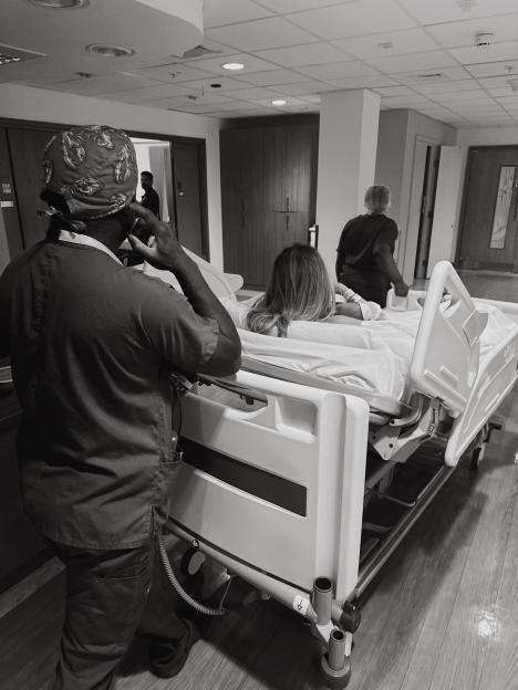 Made In Chelsea star Frankie Gaff in a hospital bed with medical personnel nearby.