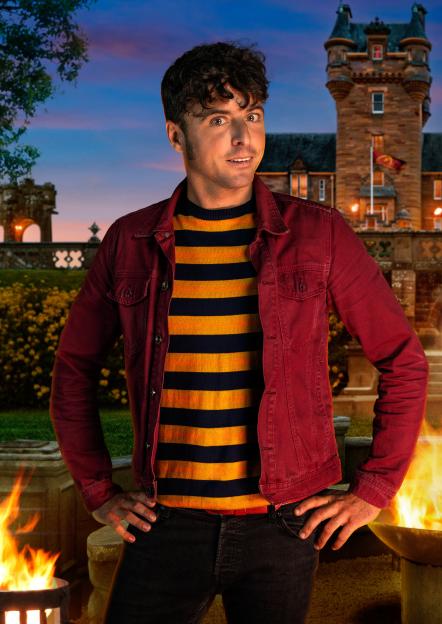 James, 38, a gardener from Weymouth, in a red jacket over a striped top, with a castle in the background.