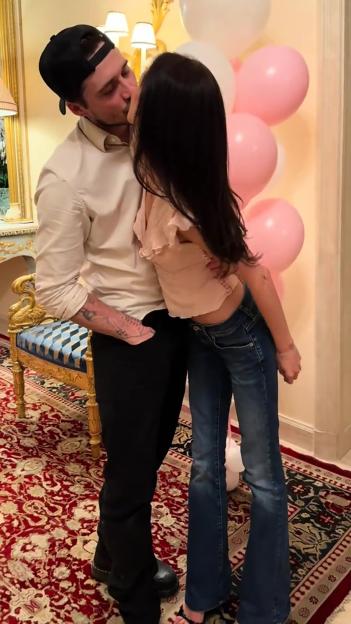 Brooklyn Beckham and Nicola Peltz kissing.