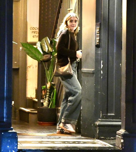 Holly Ramsay, dressed in a black top and light blue jeans, exiting the Robun Japanese sushi restaurant.