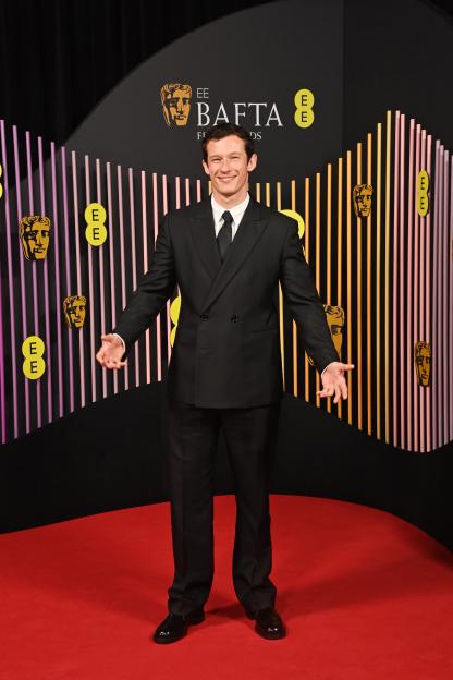 Callum Turner poses on the red carpet at the EE BAFTA Film Awards.