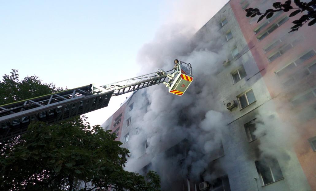 A firefighter in a crane attempting to put out a fire from a building after a rocket attack in Zaporizhzhia, Ukraine.