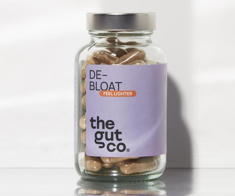 Glass bottle of The Gut Co. DE-BLOAT supplements.