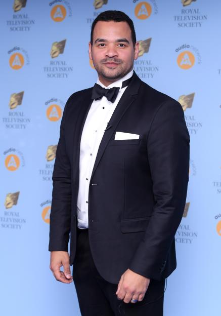 a man and woman pose in front of a sky + hd sign