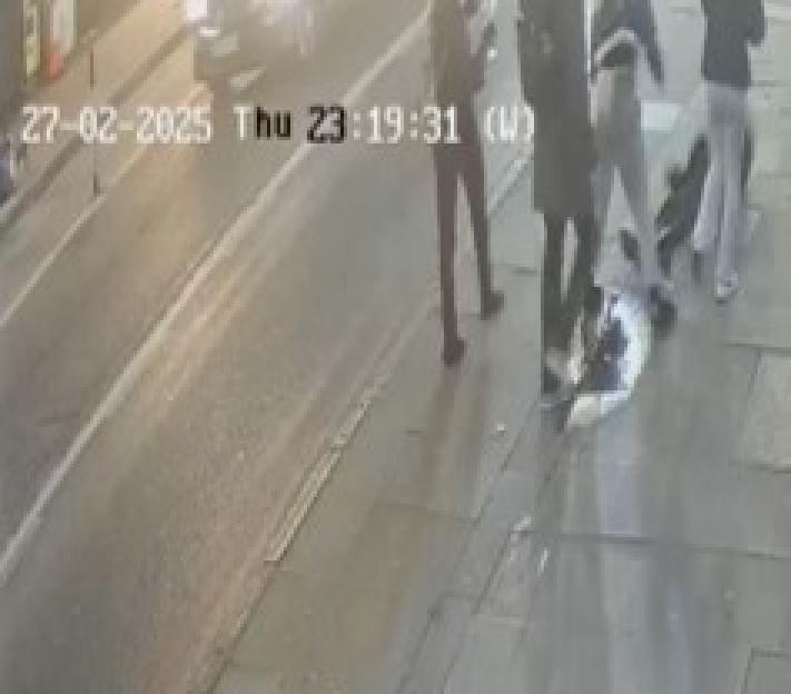 Security footage of three teenage girls assaulting Fredi Rivero on the pavement.