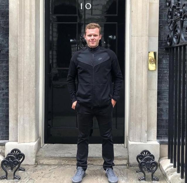 John McAvoy, prisoner turned triathlete, stands in front of the door at 10 Downing Street.