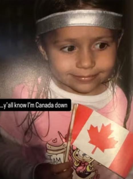 Tate McRae as a child holding a Canadian flag.