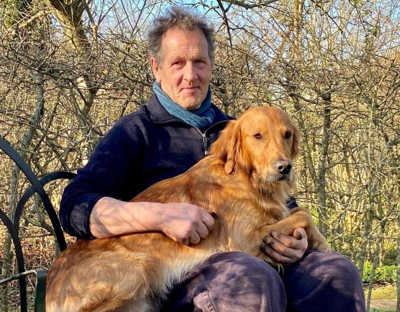 Monty Don holding his Golden Retriever, Nell.