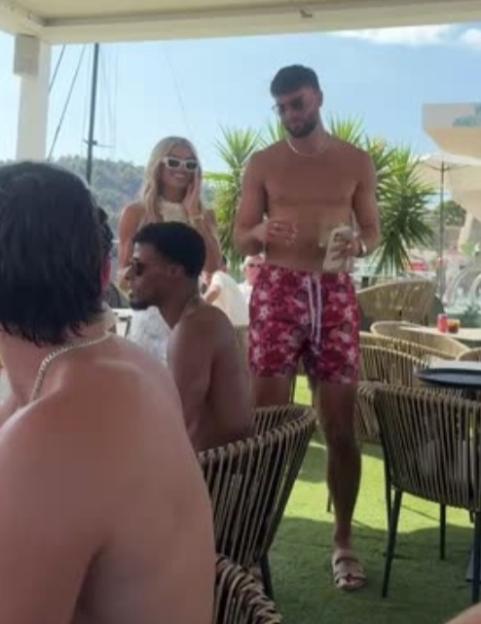 Several people relaxing at a poolside or beachside bar.