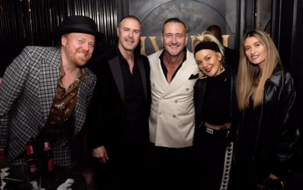 Will Mellor and Hollyoaks co-stars pose for a photo at a 50th birthday celebration.
