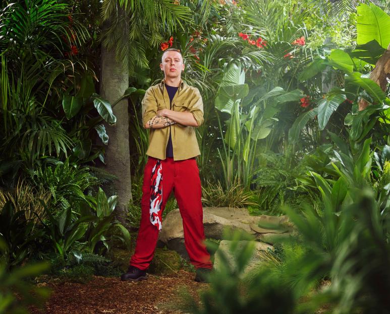 Aitch poses in a jungle setting for "I'm a Celebrity... Get Me Out of Here!" TV show.