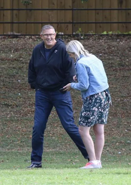 Graeme Hall, known as The Dogfather, walking outdoors outdoors with Nicola Worth.