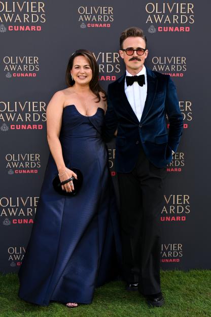 Giovanna Fletcher in a navy gown and Tom Fletcher in a blue velvet tuxedo suit at the Olivier Awards.