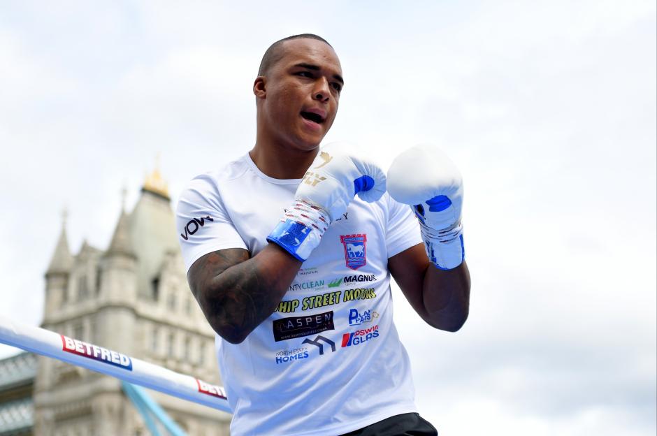 Fabio Wardley practicing in boxing gloves with the Tower Bridge in the background.