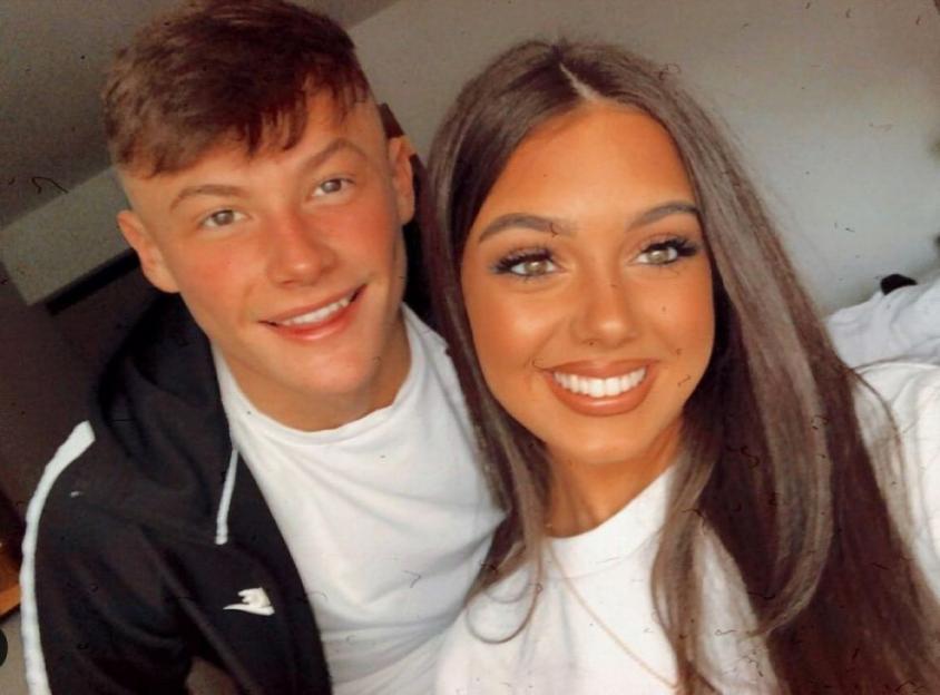 A man and a woman smiling for a photo.