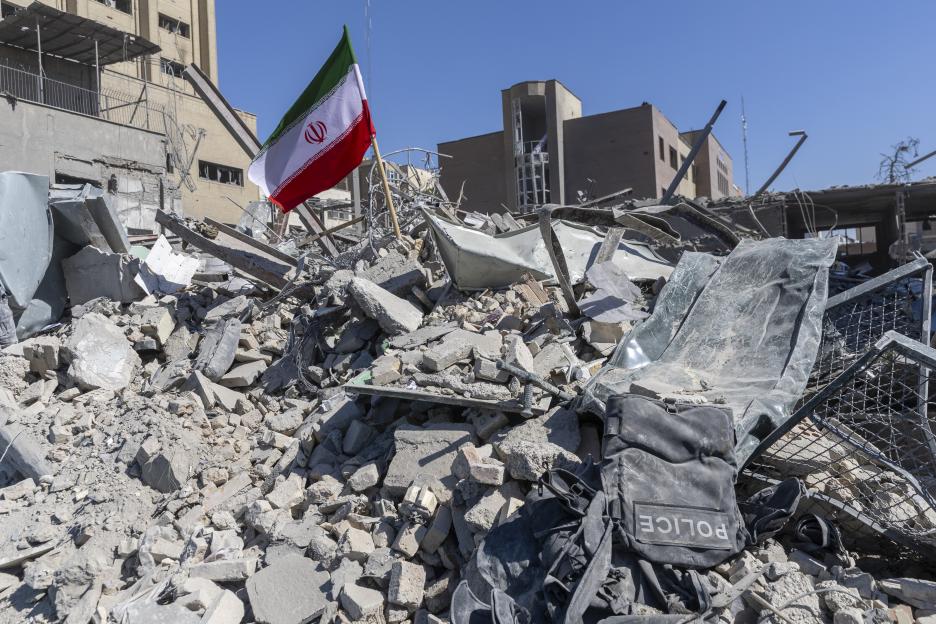 Iranian flag in the rubble of a police station damaged by airstrikes.