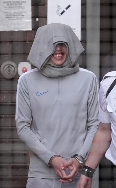 Karin Al-Danasurt in handcuffs, leaving Hove Trial Centre Crown Court.