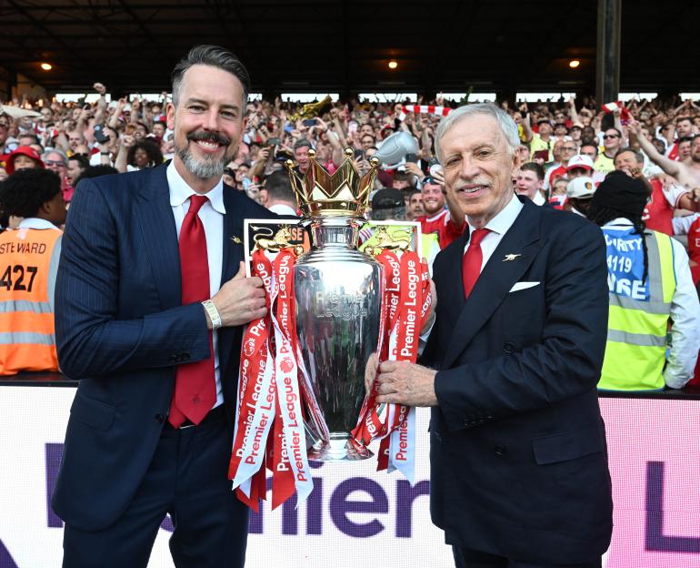 Josh Kroenke and Stan Kroenke celebrating with the Premier League trophy.