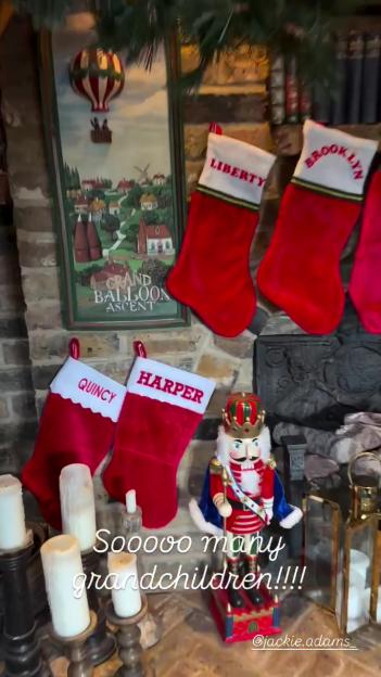 Christmas stockings named "Liberty," "Brooklyn," "Quincy," and "Harper" hanging above a fireplace with holiday decorations.