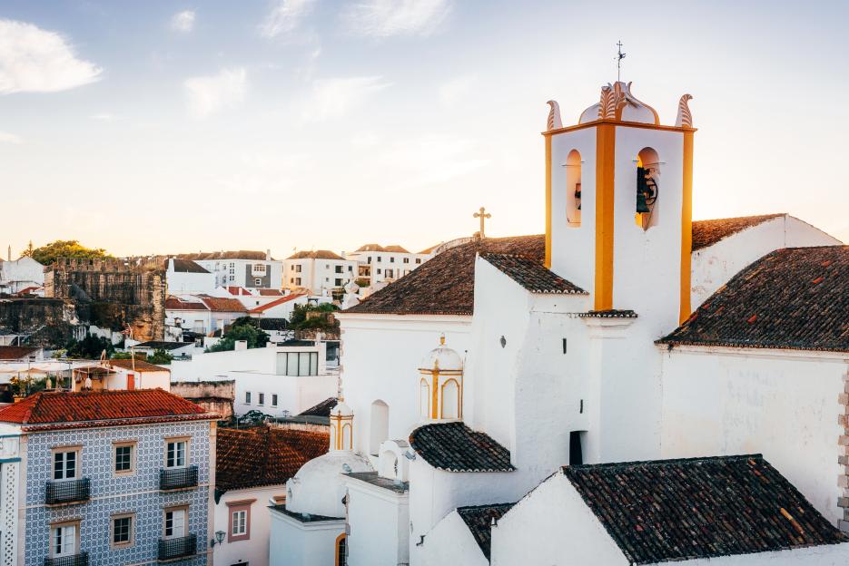 Skyline of Tavira, Portugal, with a prominent church tower.