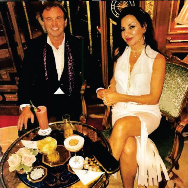 Gerry Sherard and a woman sitting at a table with drinks.