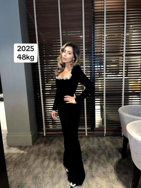 A woman in a fur-lined hood and a white athletic top, with text that reads "EAT AND BE FAT."