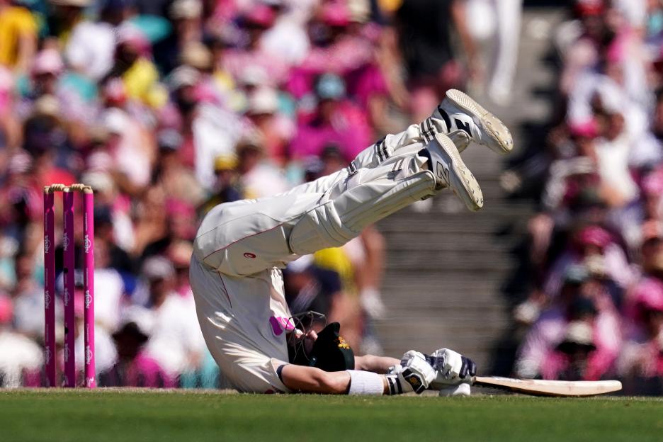 Australia's Steve Smith falls over while batting during a cricket match.