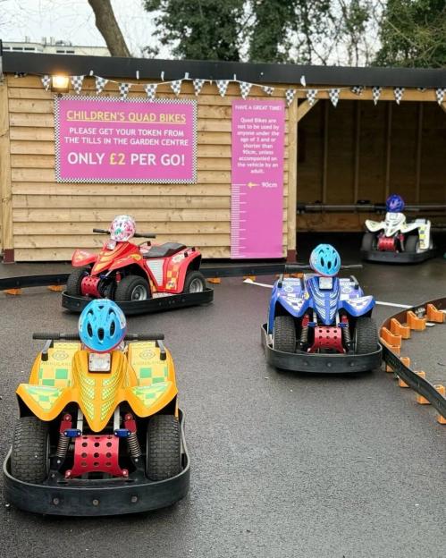 Children's quad bikes for hire, with four brightly colored bikes on a track.