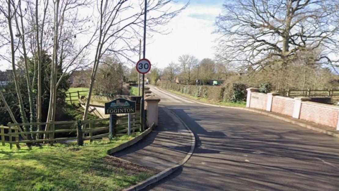 Road leading into the village of Egginton with a 30 mph speed limit sign.
