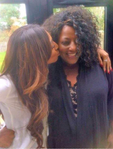 Alexandra Burke kissing her mother on the cheek.