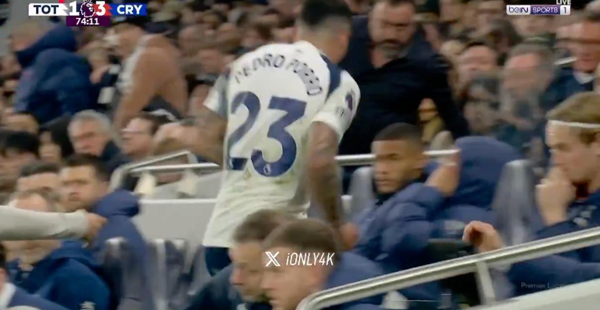 Soccer player Pedro Porro (number 23) walking off the field past other players and spectators.