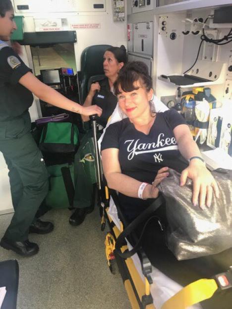 Esther Stanhope on a stretcher in an ambulance.