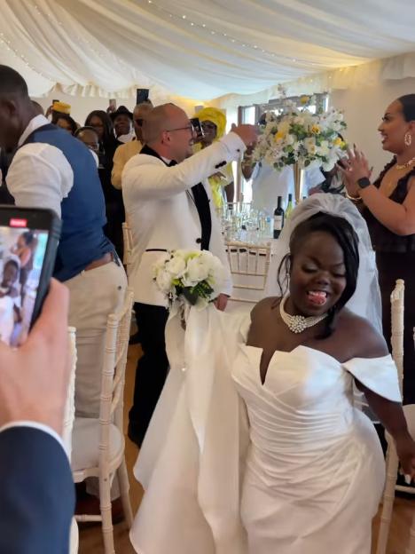 Fats Timbo smiles at her wedding to her photographer boyfriend.