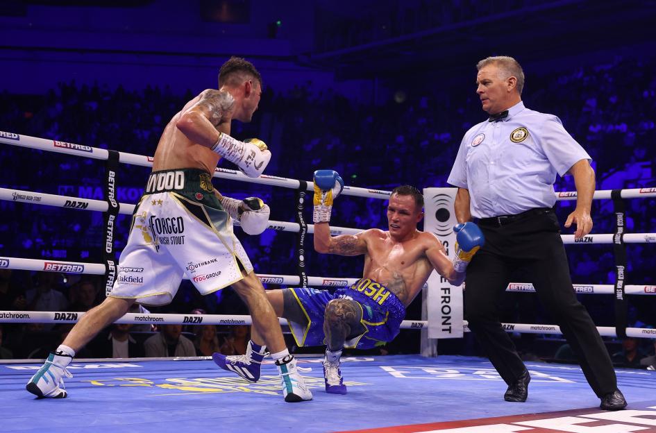 Leigh Wood knocking down Josh Warrington during their WBA Featherweight World Title fight.