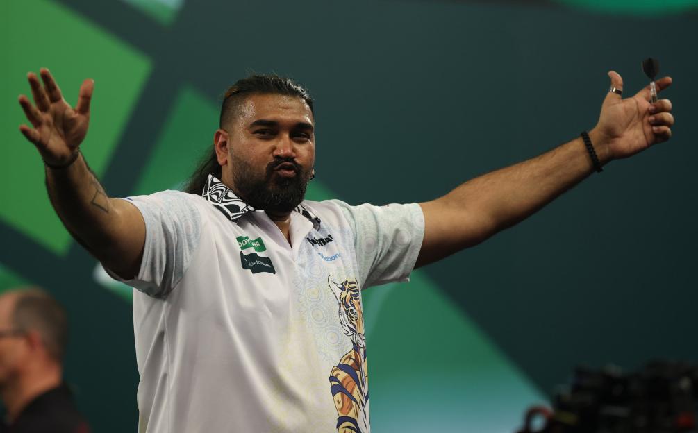 Darts player Harith Lim with his arms outstretched during the 2025/26 Paddy Power World Darts Championship.